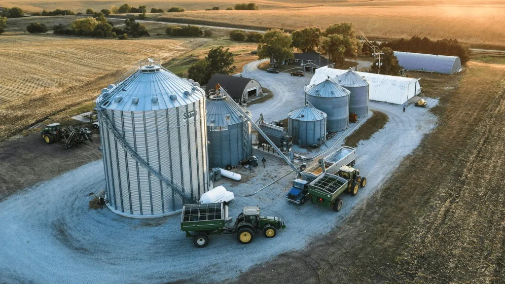 Aerial view of grain silos and harvest machinery on a farm